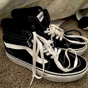 These are high top black/white vans that are size 7.